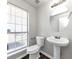 Updated bathroom with pedestal sink and large window at 508 Cascade Walk, Mcdonough, GA 30253