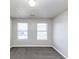 Spacious bedroom with grey carpet and two windows at 508 Cascade Walk, Mcdonough, GA 30253