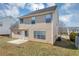 Tan house back with a patio, yard, and partial view of neighboring houses at 508 Cascade Walk, Mcdonough, GA 30253