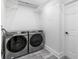 Laundry room with Samsung washer and dryer, and built-in shelving at 520 Creekwood Xing, Roswell, GA 30076