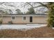 Rear view of house showing patio, yard, and landscaping at 1728 W Austin Rd, Decatur, GA 30032