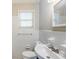 Well-lit bathroom with white tile, a modern sink, and a window at 3197 Cloverhurst Dr, Atlanta, GA 30344
