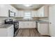 Modern kitchen with stainless steel appliances, white cabinets and a spacious layout at 3197 Cloverhurst Dr, Atlanta, GA 30344
