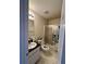 Bathroom featuring a shower with sliding glass doors, neutral walls, and vinyl flooring at 3745 Hudson Ct, Rex, GA 30273