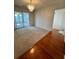 A well-lit dining room featuring hardwood flooring, a chandelier, and sliding glass doors leading to the patio at 3745 Hudson Ct, Rex, GA 30273