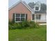 Charming brick home with lush landscaping surrounding the front, creating a welcoming curb appeal at 3745 Hudson Ct, Rex, GA 30273