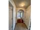 Hallway showcasing arched doorways, multiple storage closets, and access to the living area at 3745 Hudson Ct, Rex, GA 30273