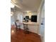 Kitchen with white cabinets, black appliances, breakfast bar, and arched openings to the living room at 3745 Hudson Ct, Rex, GA 30273