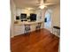 Kitchen featuring white cabinets, black appliances, a breakfast bar, and wood floors at 3745 Hudson Ct, Rex, GA 30273
