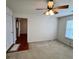 Living room with ceiling fan, neutral walls, and carpet flooring at 3745 Hudson Ct, Rex, GA 30273
