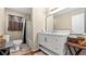 Bathroom features a white vanity with marble top and a shower/tub combo at 3870 N Shelby N Ln, Douglasville, GA 30135