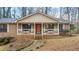 Inviting front porch with orange door and white railings at 3870 N Shelby N Ln, Douglasville, GA 30135