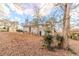 House's back view, backyard with tree and sloped terrain at 2249 Clanton Ter, Decatur, GA 30034