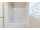 Simple bathroom with a white tub and tiled walls at 2249 Clanton Ter, Decatur, GA 30034