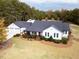 Spacious farmhouse with detached garage, large backyard, and mature trees at 5601 Atlanta Hwy, Rutledge, GA 30663