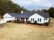 Stunning aerial view of a farmhouse with a spacious yard at 5601 Atlanta Hwy, Rutledge, GA 30663