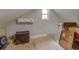 Unfinished attic space with window and storage at 5601 Atlanta Hwy, Rutledge, GA 30663