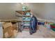 Unfinished attic space with shelving for storage at 5601 Atlanta Hwy, Rutledge, GA 30663