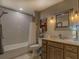 Modern bathroom with a shower/tub combo and wood vanity at 5601 Atlanta Hwy, Rutledge, GA 30663