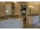 Elegant bathroom with double vanity, granite countertop, and patterned tile floor at 5601 Atlanta Hwy, Rutledge, GA 30663