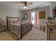 Charming bedroom with floral bedding and a ceiling fan at 5601 Atlanta Hwy, Rutledge, GA 30663
