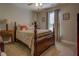 Bright bedroom with a wooden bed frame and neutral decor at 5601 Atlanta Hwy, Rutledge, GA 30663