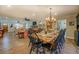 Bright dining room with wooden farmhouse table and hardwood floors at 5601 Atlanta Hwy, Rutledge, GA 30663