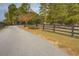 Driveway entrance with a black fence and trees at 5601 Atlanta Hwy, Rutledge, GA 30663