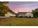 Stunning ranch home with attached two-car garage, charming front porch, and expansive lawn at 5601 Atlanta Hwy, Rutledge, GA 30663
