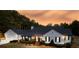 Stunning white farmhouse with black trim, large windows, and a three-car garage at 5601 Atlanta Hwy, Rutledge, GA 30663