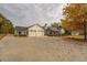 White farmhouse exterior with a large driveway and three-car garage at 5601 Atlanta Hwy, Rutledge, GA 30663