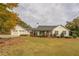 White farmhouse with black shutters, attached garage, and landscaped yard at 5601 Atlanta Hwy, Rutledge, GA 30663