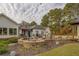 Stone fire pit with seating area and landscaping at 5601 Atlanta Hwy, Rutledge, GA 30663
