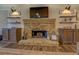 Stone fireplace with built-in shelving and hardwood floors at 5601 Atlanta Hwy, Rutledge, GA 30663