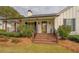 Charming front porch with wooden steps and black railings at 5601 Atlanta Hwy, Rutledge, GA 30663