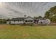 Home's back features a large yard, stone patio, and detached garage at 5601 Atlanta Hwy, Rutledge, GA 30663