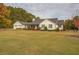Charming farmhouse exterior with attached garage and large yard at 5601 Atlanta Hwy, Rutledge, GA 30663