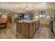 Open kitchen with large island, white cabinets, and hardwood floors at 5601 Atlanta Hwy, Rutledge, GA 30663