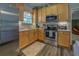 Modern kitchen with stainless steel appliances and light wood cabinets at 5601 Atlanta Hwy, Rutledge, GA 30663