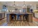 Modern kitchen with large island, white cabinets, and hardwood floors at 5601 Atlanta Hwy, Rutledge, GA 30663