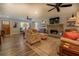 Living room with stone fireplace and hardwood floors at 5601 Atlanta Hwy, Rutledge, GA 30663