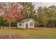 White storage shed with black trim in the backyard at 5601 Atlanta Hwy, Rutledge, GA 30663