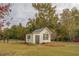 White storage shed with black trim in the backyard at 5601 Atlanta Hwy, Rutledge, GA 30663