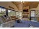 Sunroom addition with a fireplace, vaulted ceiling and large windows at 5601 Atlanta Hwy, Rutledge, GA 30663