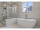 Luxury bathroom with freestanding tub, glass shower, and modern fixtures at 2910 Caney Parc Way, Cumming, GA 30041