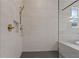 Modern bathroom with walk-in shower, hexagon tile floor, and built-in shelf at 2910 Caney Parc Way, Cumming, GA 30041