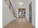 Light and airy entryway with hardwood floors and modern staircase at 2910 Caney Parc Way, Cumming, GA 30041