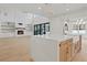 Modern kitchen with a large island, white cabinets, and a farmhouse sink at 2910 Caney Parc Way, Cumming, GA 30041