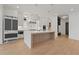 Modern kitchen with white cabinets, large island, and stainless steel appliances at 2910 Caney Parc Way, Cumming, GA 30041