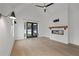 Light-filled living room with hardwood floors, fireplace, and access to backyard at 2910 Caney Parc Way, Cumming, GA 30041